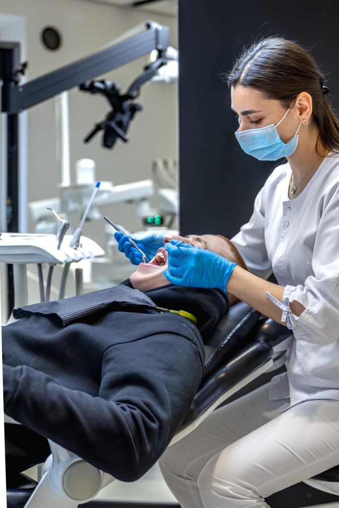 female-dentist-treats-patients-teeth-stomatologist-working-with-professional-equipment